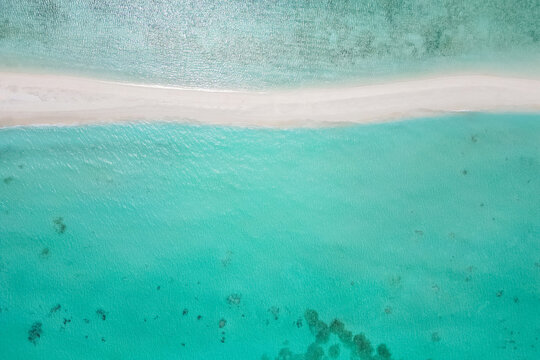 stunning blue ocean and sandy white island maldives top drone aeral view deserted hidden Maldives beach copyspace for text