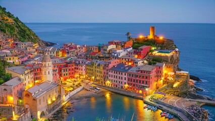 Picturesque view of a vibrant harbor illuminated by the night sky: Cinque Terre, Italy