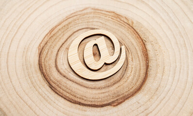 Wooden email symbol on grunge wood growth rings background