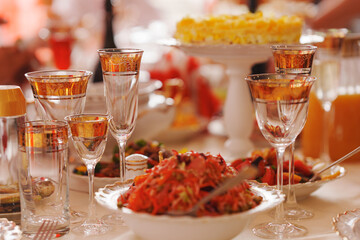 salad on the table is served with classic white and gold dishes. Table setting for a banquet.