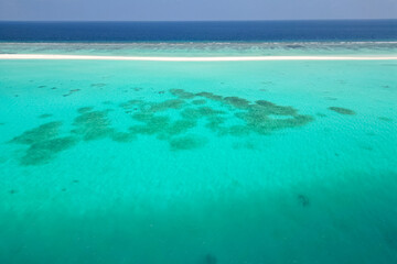 stunning blue ocean and sandy white island maldives top drone aeral view deserted hidden Maldives beach copyspace for text