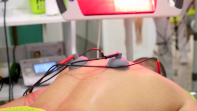 Footage of a back pain infrared treatment at the physiotherapist