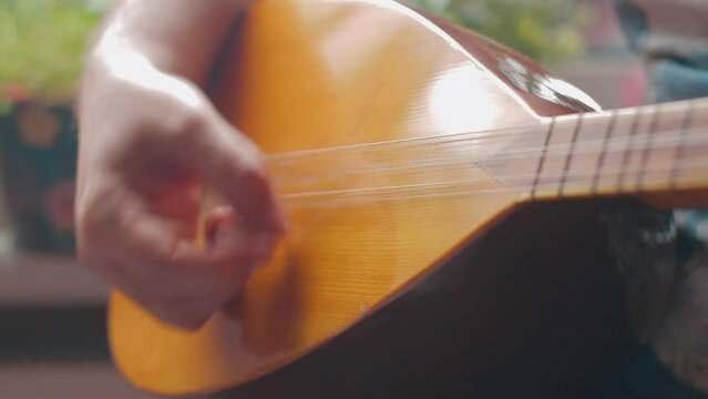  Man playing Turkish musical instrument baglama