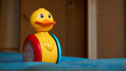 A yellow red and blue toy duck