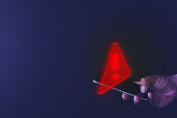 Handheld Smartphone Featuring Triangle Caution Icons: Highlighting Mobile Technology and Digital Warnings.