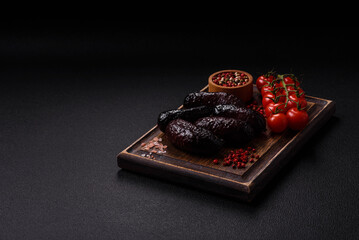 Delicious black blood sausage or black pudding with spices and herbs