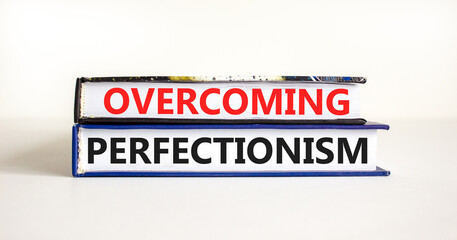 Overcoming perfectionism symbol. Concept words Overcoming perfectionism on beautiful books. Beautiful white paper background. Business Overcoming perfectionism concept. Copy space.