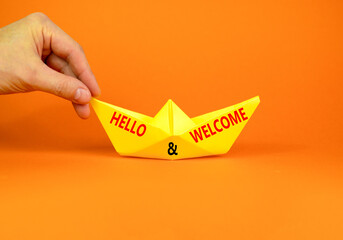 Hello and welcome symbol. Concept words Hello and welcome on beautiful yellow paper boat. Beautiful...