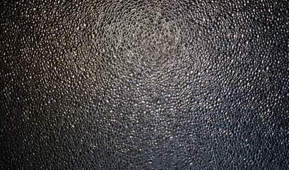 Embossed uneven texture dark glass surface, abstract background. relief pattern corrugated opaque...