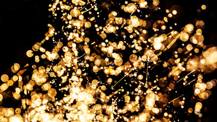 Golden bokeh light created by sunlight and water spray