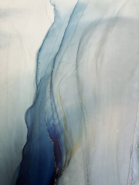 Abstract blue background with gold and bronze &mdash; fluid art texture made with alcohol ink and liquid potal. Blue with gold natural art backdrop resembles watercolor or aquarelle.