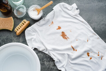 Splashing cosmetic cream or foundation on a white t-shirt. Natural cleaning products. Environmental...