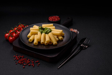 Delicious pasta with spinach sauce, olive oil and parmesan cheese