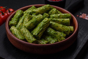 Delicious pasta with spinach sauce, olive oil and parmesan cheese