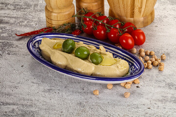 Tasty hummus with green olives