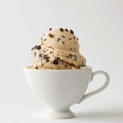 Espresso chip ice cream in a coffee cup, styled minimally against a white background. 