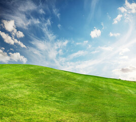 A sunny landscape unfolds, featuring meticulously trimmed green grass under a majestic sky