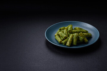 Delicious pasta with spinach sauce, olive oil and parmesan cheese