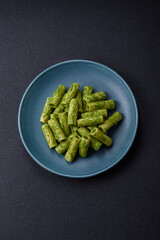 Delicious pasta with spinach sauce, olive oil and parmesan cheese