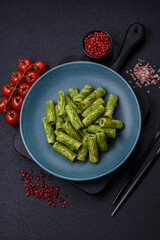 Delicious pasta with spinach sauce, olive oil and parmesan cheese