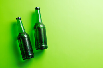 Beer bottles on green background