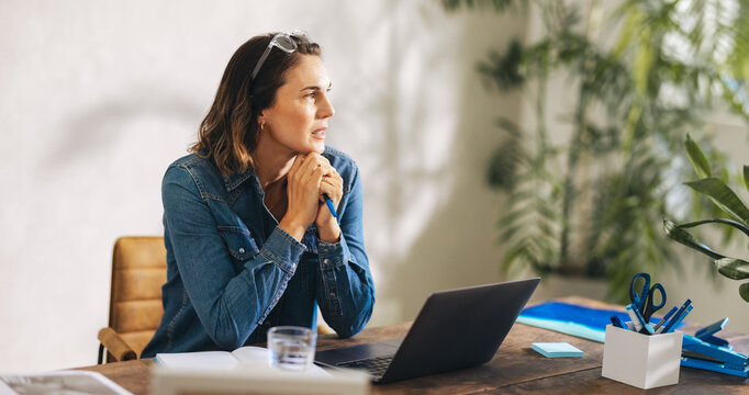 Pensive businesswoman in a stylish denim jacket