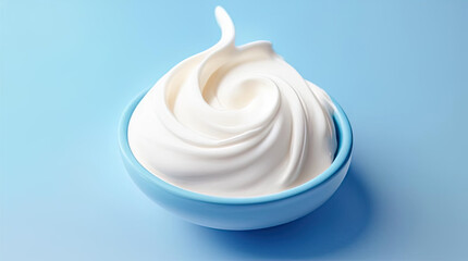 white cream in a blue bowl. white pasta in a plate on a blue background