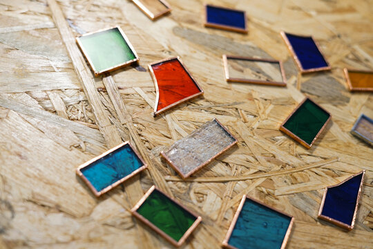 Pieces of colorful glass and tooles. Stained glass workshop. 