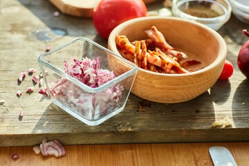 Step-by-step cooking process. Pour the purple onion into a glass bowl.