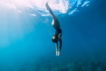 Woman swims in clear sea. Freediving and beautiful lady in ocean