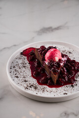 chocolate dessert with ice cream and berry syrup