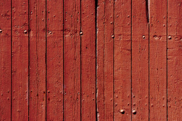 Vertical rustic wood planks with lots of texture in red tones.