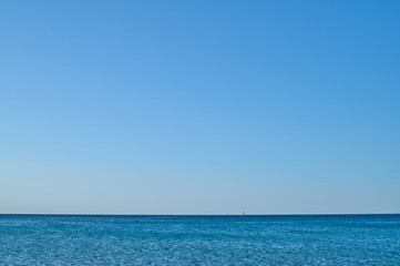 Obraz premium A sailboat on the beach of Les Bovetes, near Denia. Alicante. Valencian Community. Spain