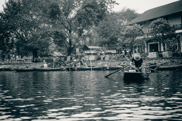 a fisherman fixing his boat in the Tam Coc River in Ninh Ninh, Vietnam