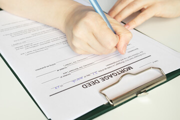 Mortgage deed, hand fills out a document, finance, investment, bank, loan application