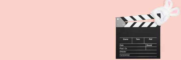 Obraz premium clapper board and easter bunny ears, movie production, entertainment industry, action scene,holiday decoration, happy celebration, entertainment banner