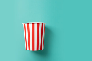 Popcorn bucket, cinematic snack time, classic movie food,green background