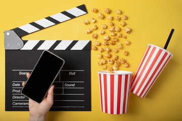 Cinema mobile app, movie tickets online, Popcorn bucket with soda cup and clapper board with phone