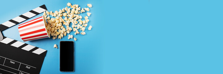 Cinema online, mobile app, Popcorn bucket and clapper board with phone, digital movie ticket, streaming blockbuster films, smartphone entertainment