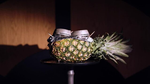 Pineapple hookah with a cloud filled with hot coals.