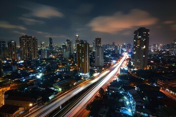 Obraz premium Long Exposure of Night Cityscape with Reflections and Light Trails