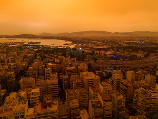 Athens,Greece,April 23,2024.Dust from Africa covers everything.View from a drone at sunset ,Palio...