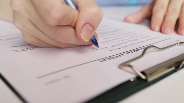 Financial affidavit, hand fills out a document, legal paperwork, lawyer review.
