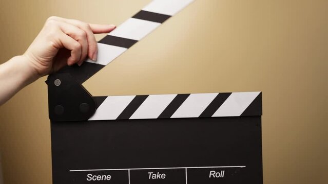 hands with clapperboard, stage performance underway, clapper signaling the beginning of an act, live entertainment