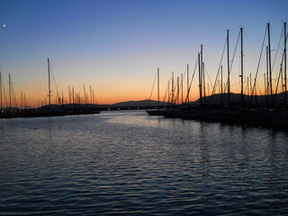 Sunset in Italy Sardinia. Serene evening in Sardinia's Alghero, where the sun dips below the horizon, casting a warm, golden glow across the tranquil waters of the Mediterran Sea.