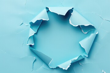 Hole in blue paper with torn edge.