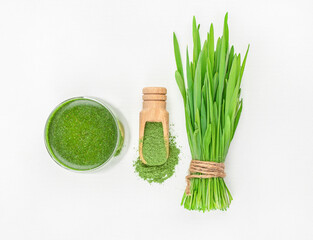 Fresh wheat grass and powder on white background, Healthy drink with organic green smoothie, Detox superfood.