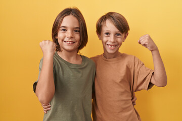 Two excited boys cheering triumphantly, raising arms in victory, hugging amidst screams of success,...