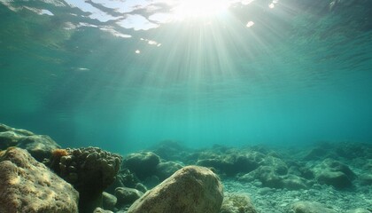 sun rays reaching the rocky bottom of the sea with clear cyan water sunny ocean landscape