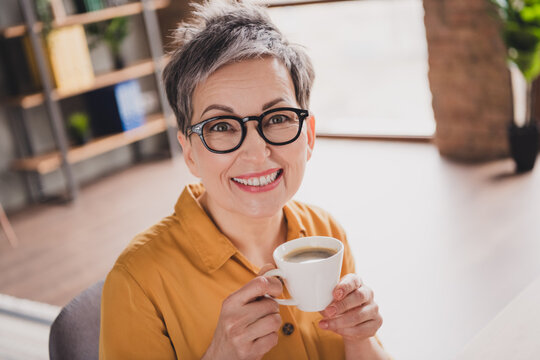 Photo of pretty retired woman drink coffee beverage dressed yellow formalwear modern workplace working home distance office